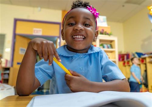 Young Girl holding a pencil 